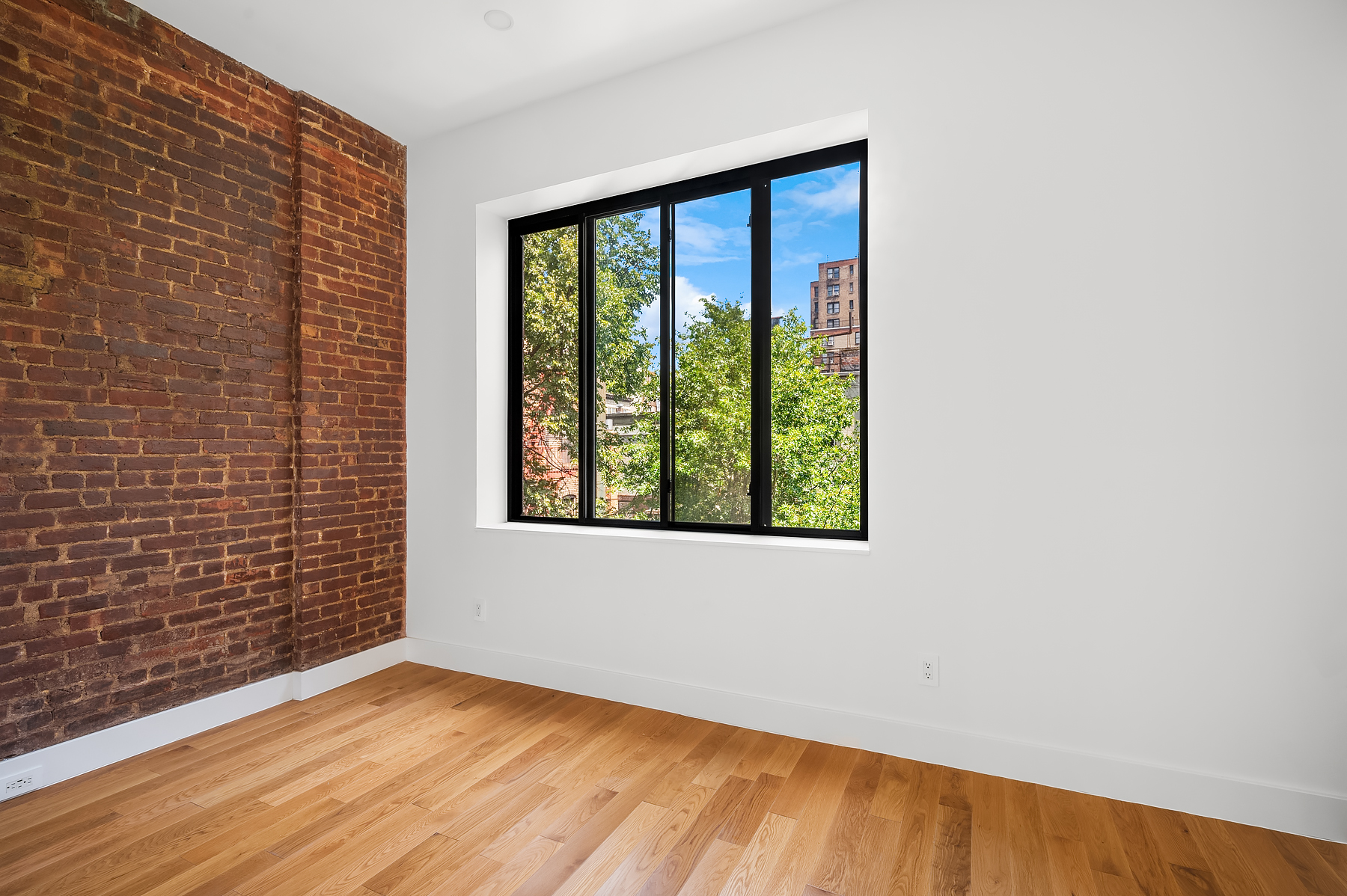 61 West 70th Street, Unit PH Manhattan, NY 10023 - Photo 13 of 18 a view of an empty room with wooden floor and a window