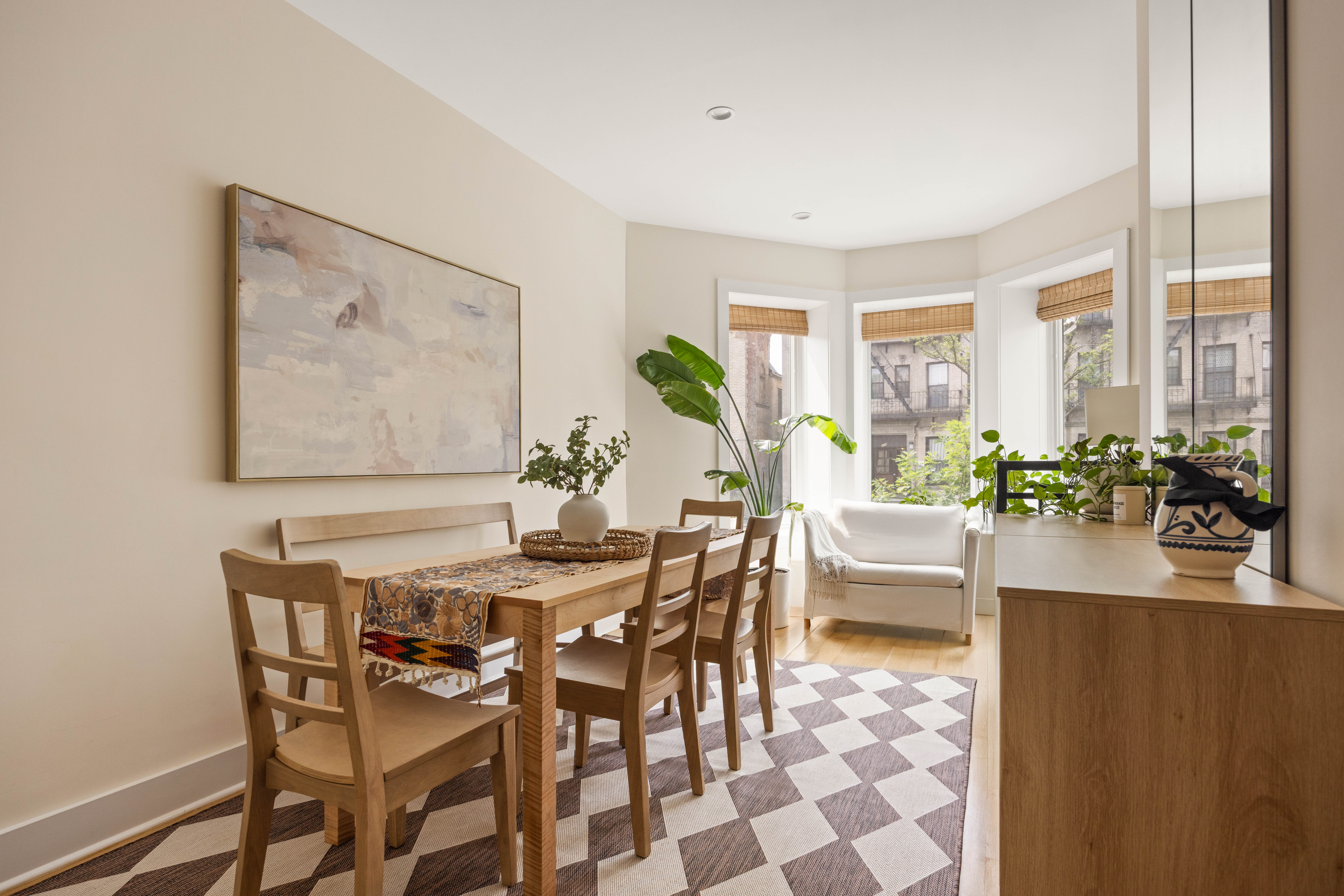 473 Bainbridge Street, Unit 1 Brooklyn, NY 11233 - Photo 5 of 15 a view of a dining room with furniture and a potted plant