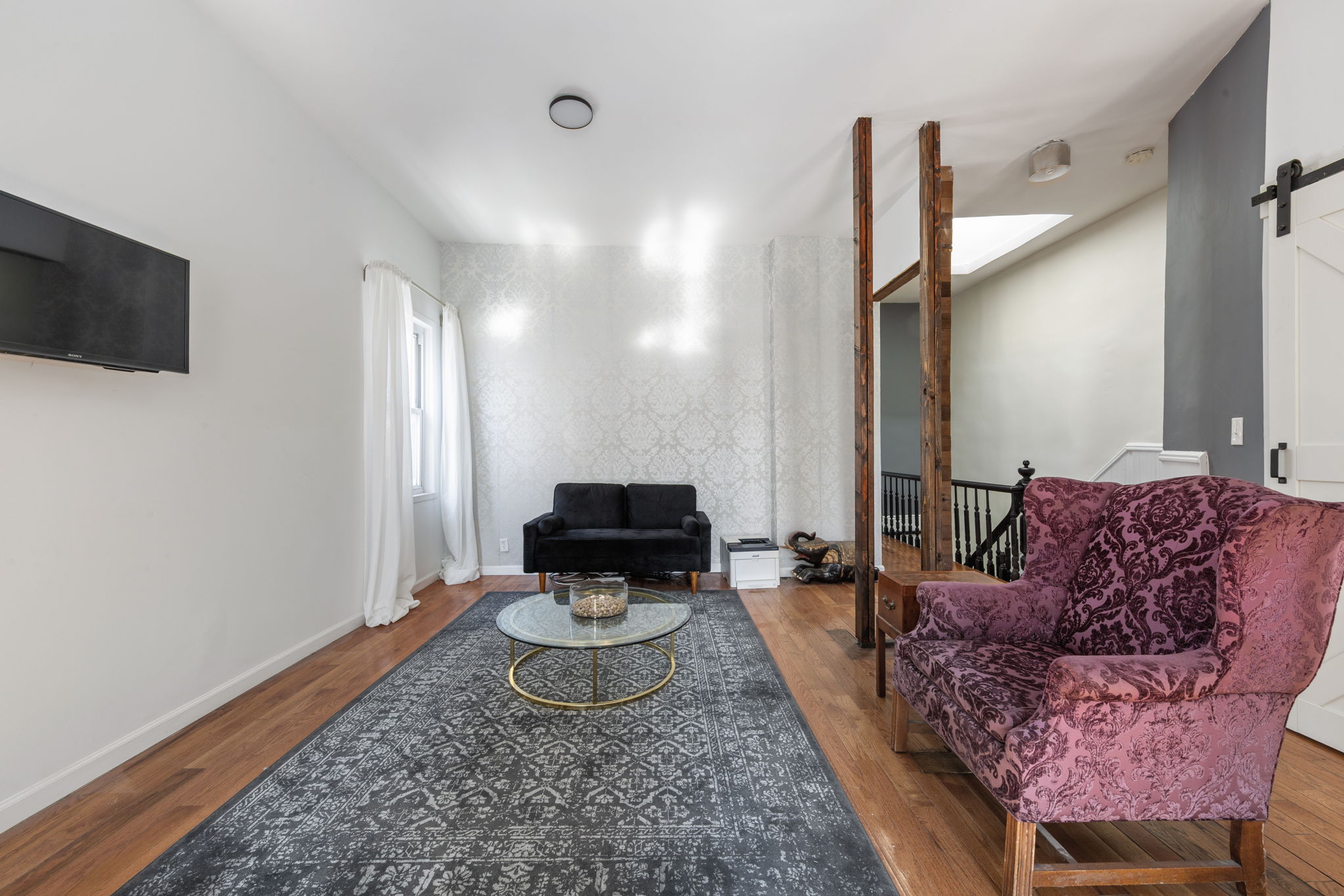 1218 Saint Marks Avenue Brooklyn, NY 11213 - Photo 6 of 42 a living room with furniture and a rug