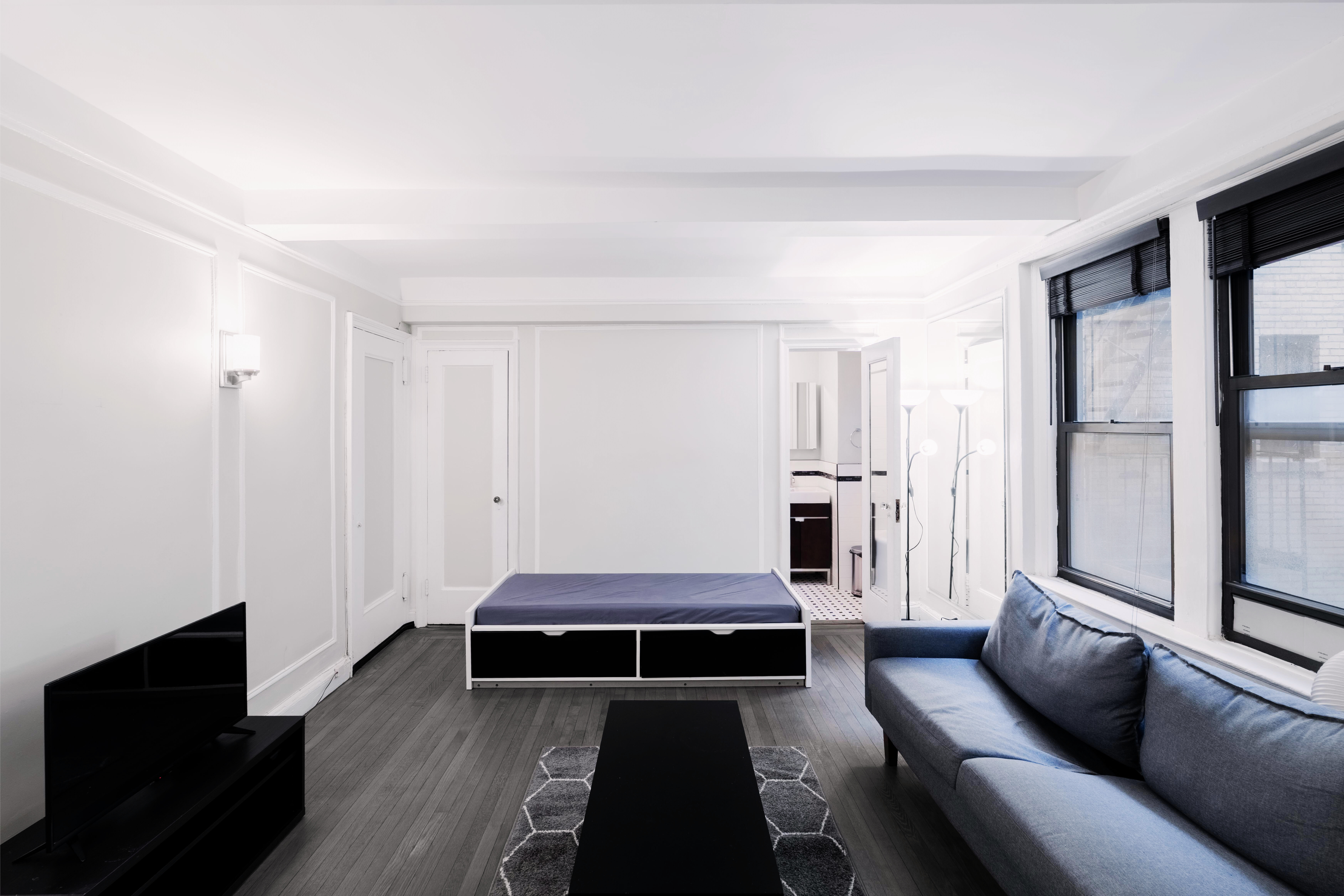 321 East 54th Street, Unit 3D Manhattan, NY 10022 - Photo 2 of 7 a living room with furniture and a flat screen tv