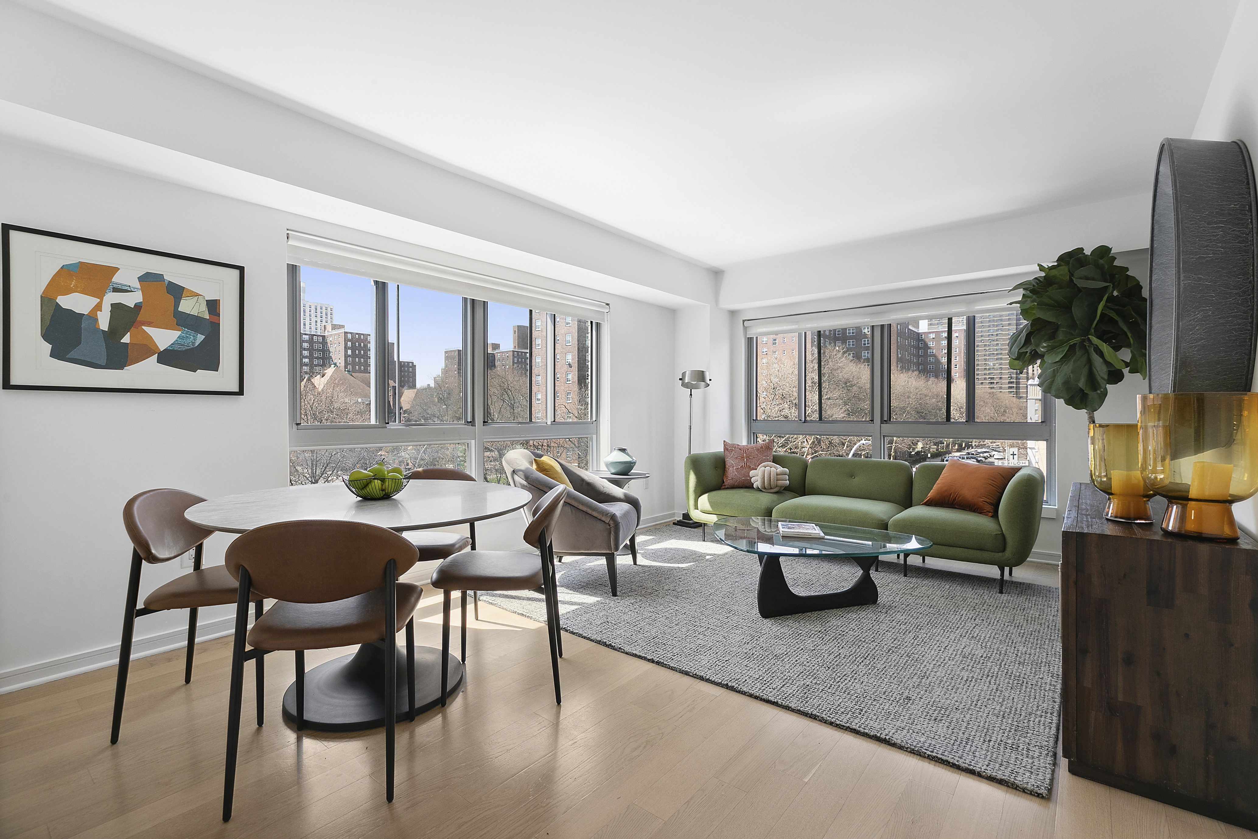 a living room with furniture and a potted plant