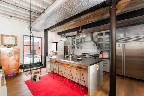 a kitchen with stainless steel appliances granite countertop a sink and a wooden cabinets