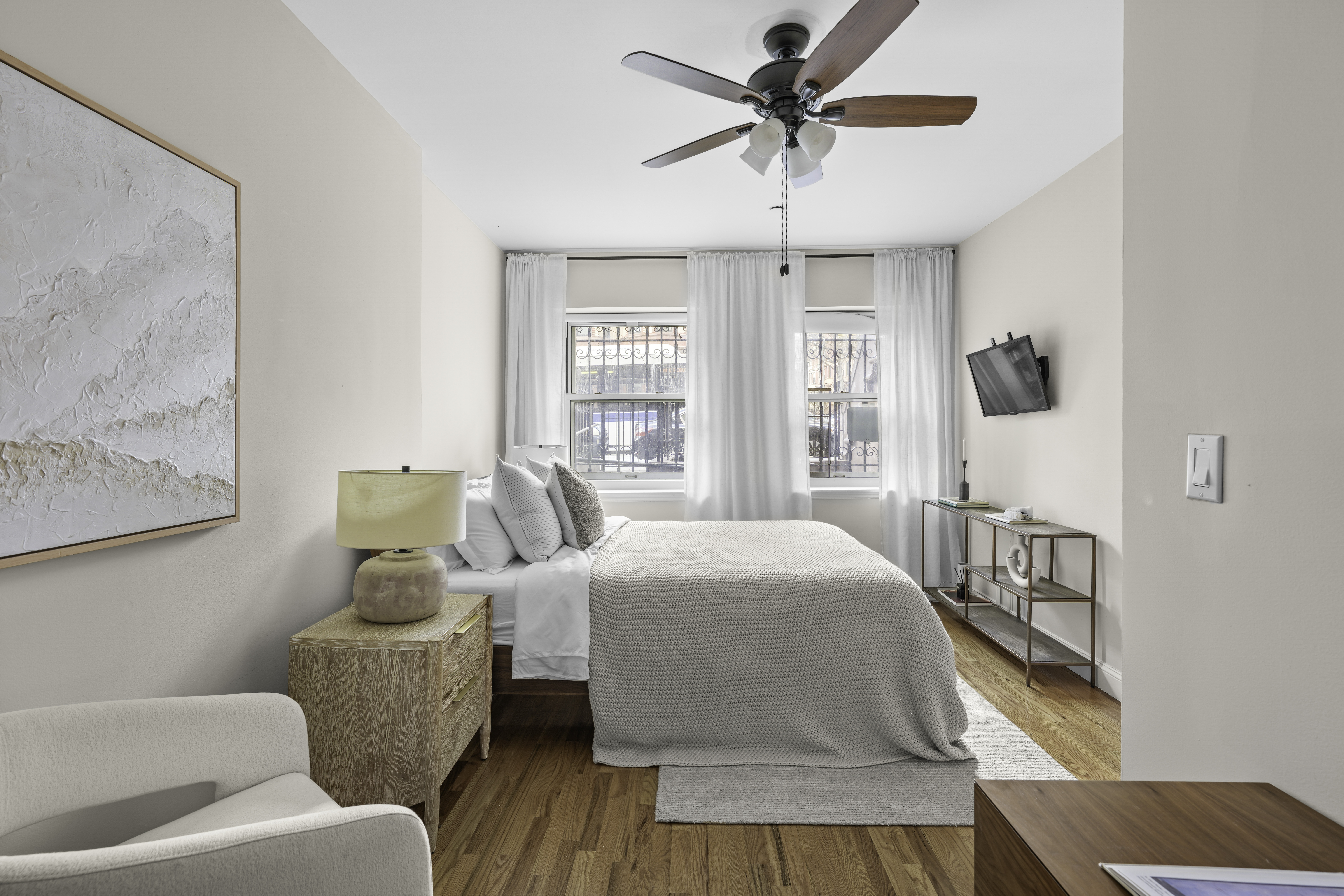 714 St Nicholas Avenue, Unit 1 Manhattan, NY 10031 - Photo 6 of 18 a bedroom with a bed and wooden floor