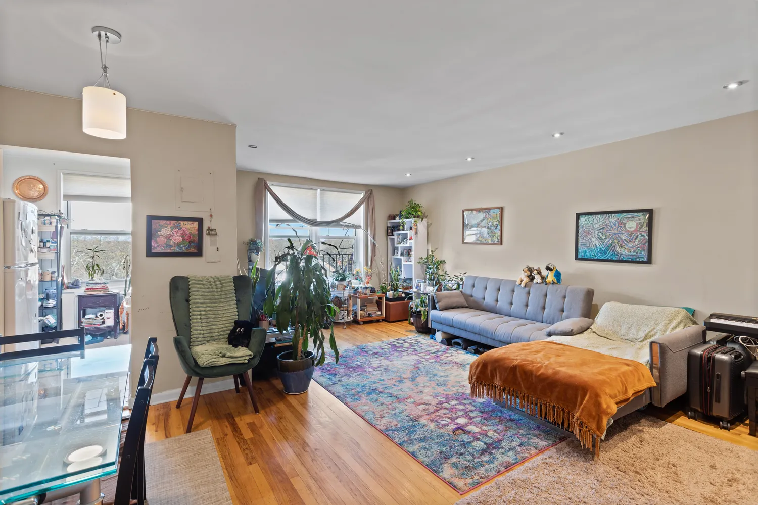 a living room with furniture and a wooden floor