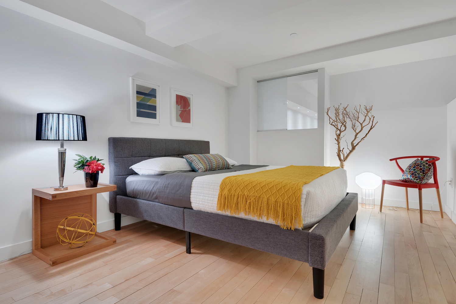 15 Broad Street, Unit 1230 Manhattan, NY 10005 - Photo 6 of 23 a bedroom with a bed and a lamp