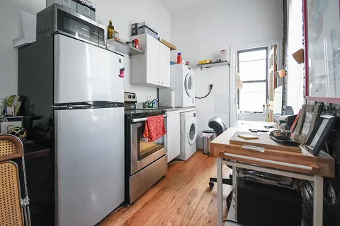 a view of storage and utility room with washer and dryer