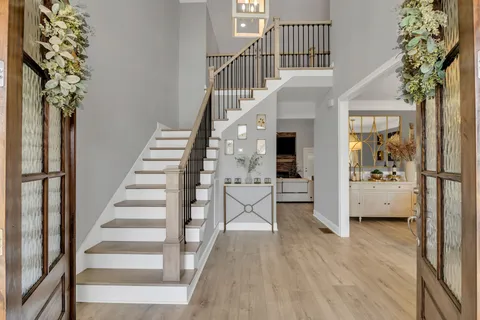 a view of entryway with wooden floor and stairs