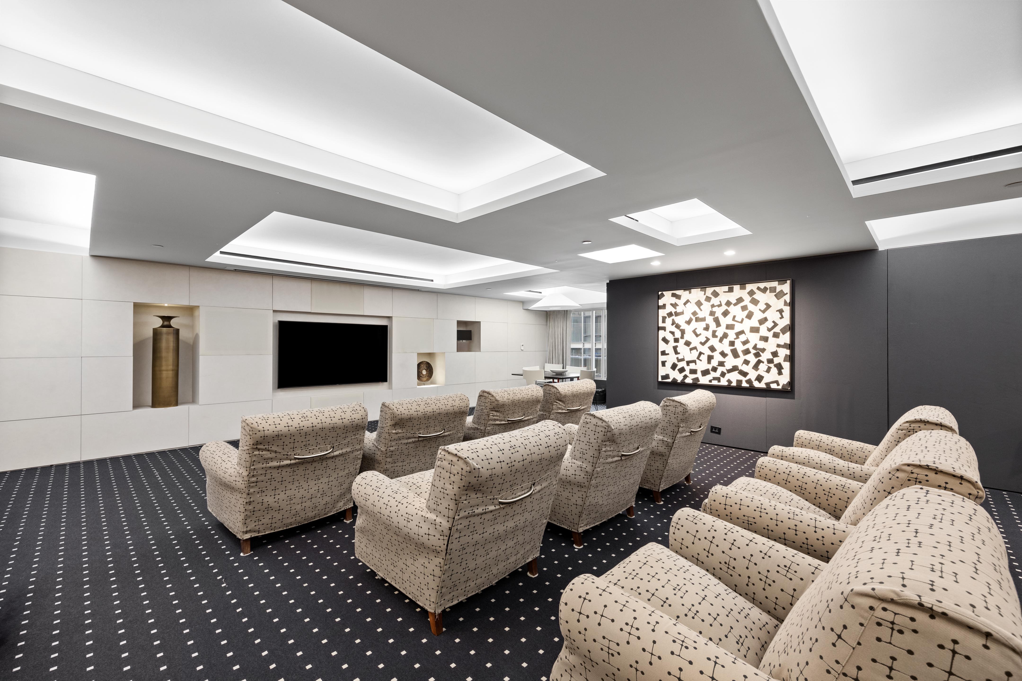 15 West 53rd Street, Unit 10H Manhattan, NY 10019 - Photo 10 of 11 a living room with furniture or couch and a flat screen tv