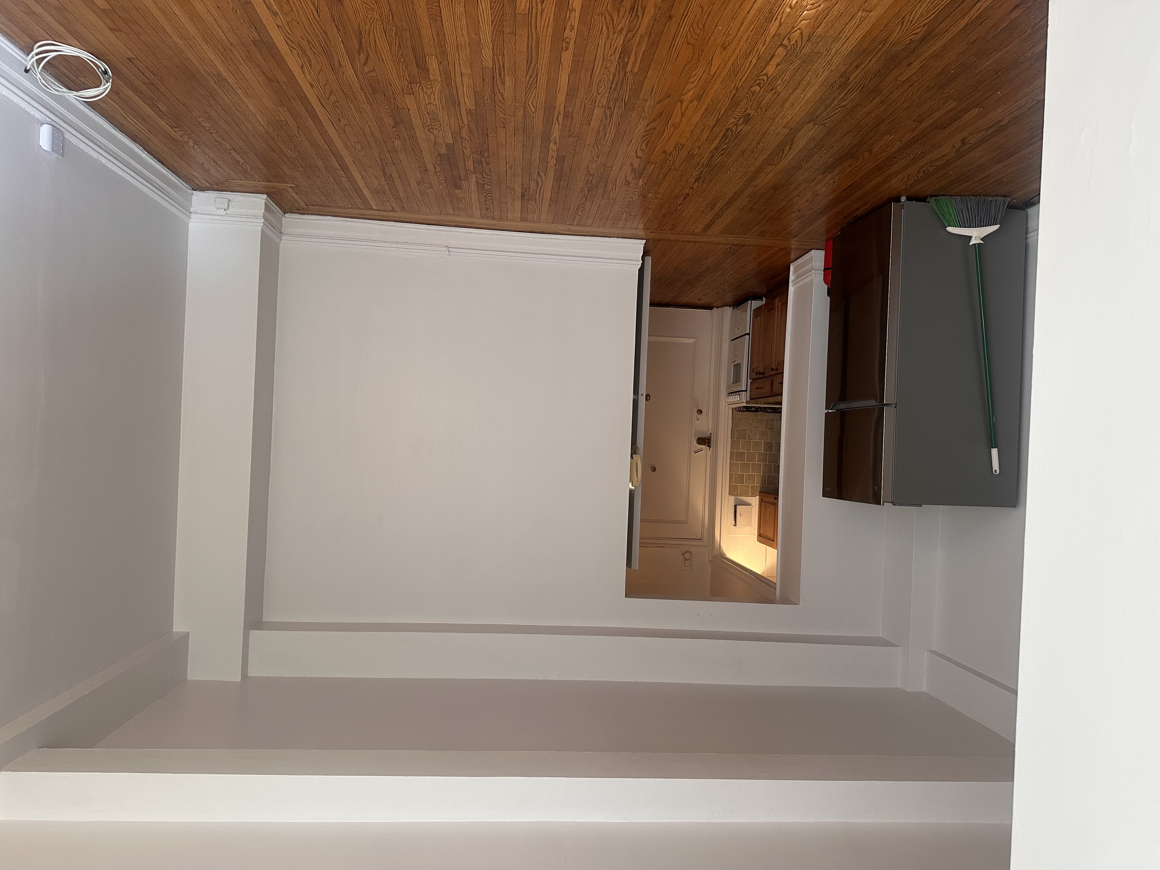 457 West 57th Street, Unit 505 Manhattan, NY 10019 - Photo 7 of 10 a view of an empty room with wooden floor and a window