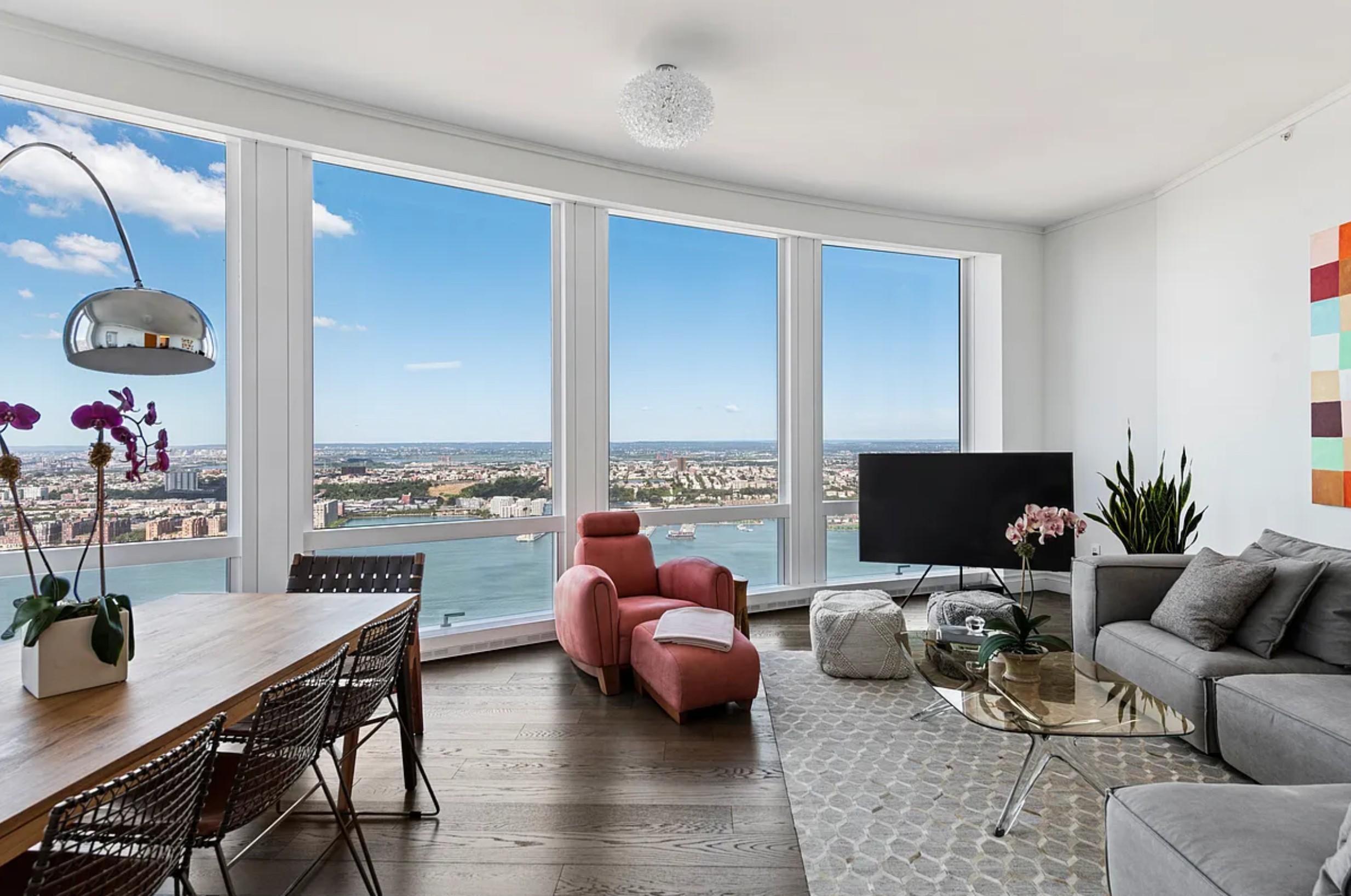 35 Hudson Yards, Unit 6701 Manhattan, NY 10001 - Photo 2 of 23 a living room with furniture and a flat screen tv