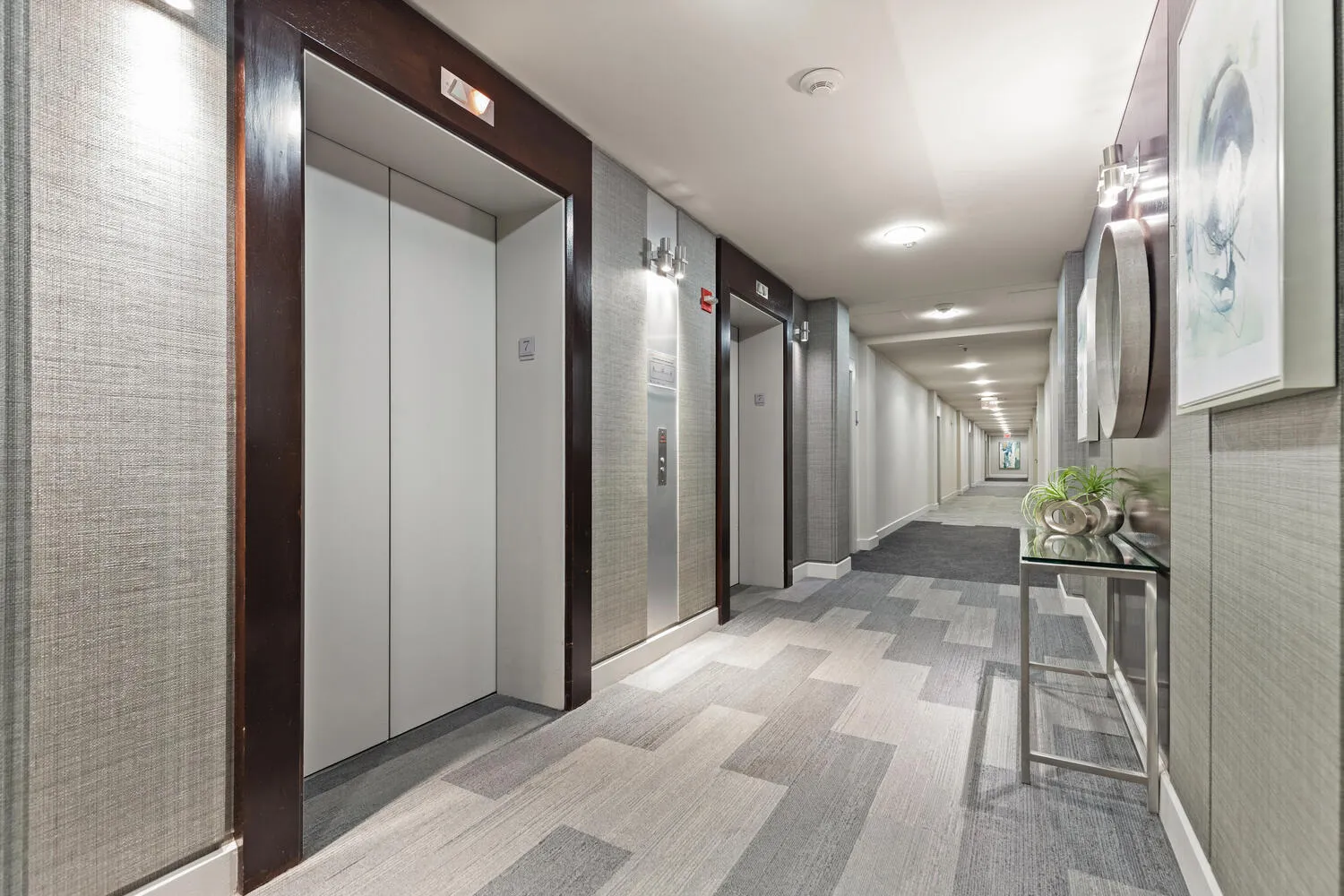 a living room with furniture and a potted plant