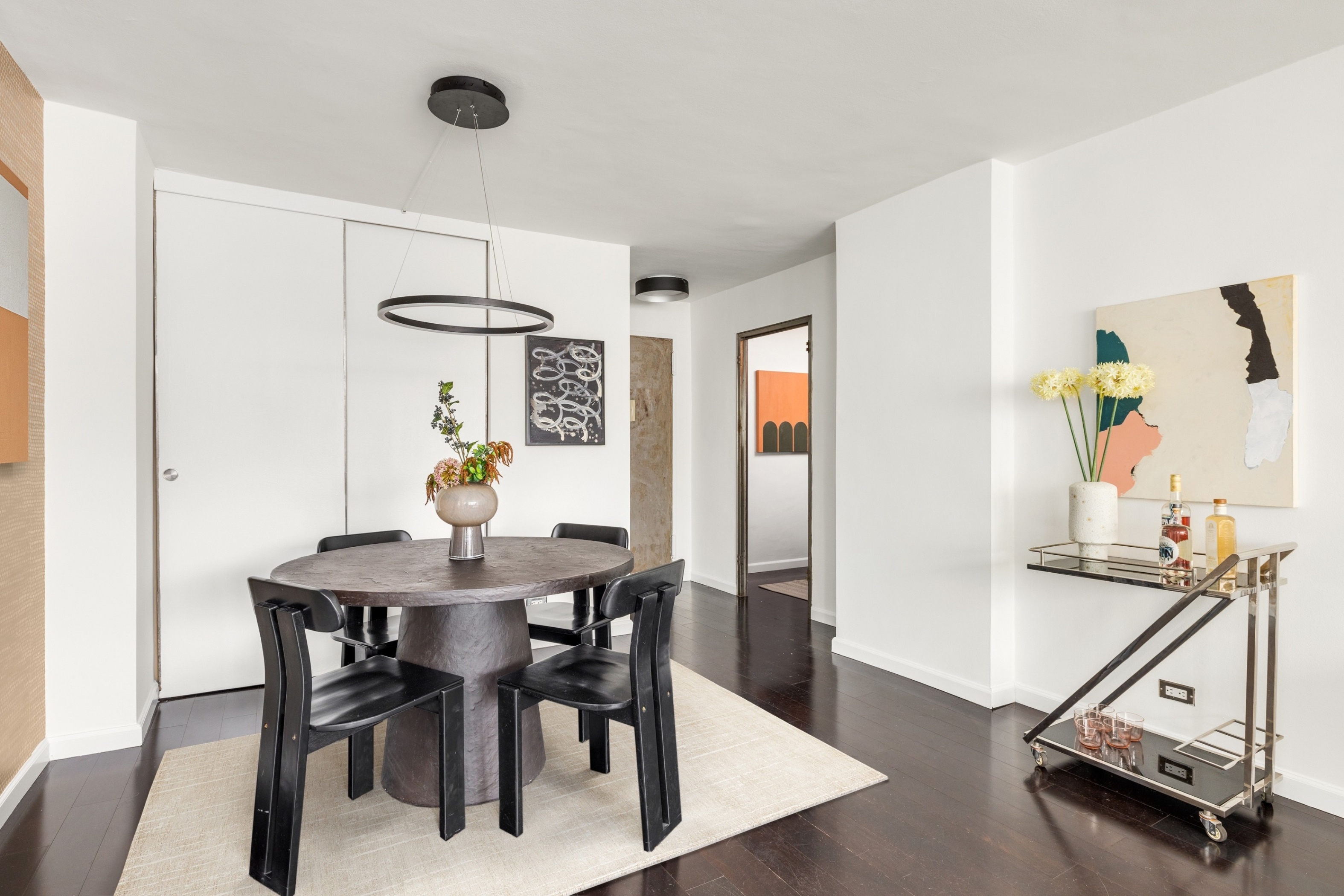 10 West 15th Street, Unit 1721 Manhattan, NY 10011 - Photo 3 of 10 a view of a dining room with furniture and wooden floor