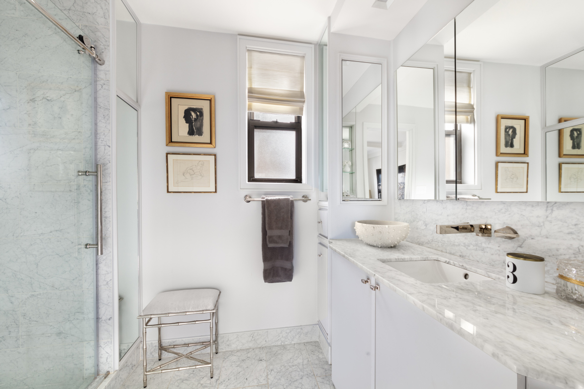 65 East 96th Street, Unit 15D Manhattan, NY 10128 - Photo 7 of 13 a bathroom with a sink and a mirror