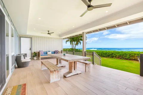 a view of a patio with dining table and chairs with wooden floor and fence