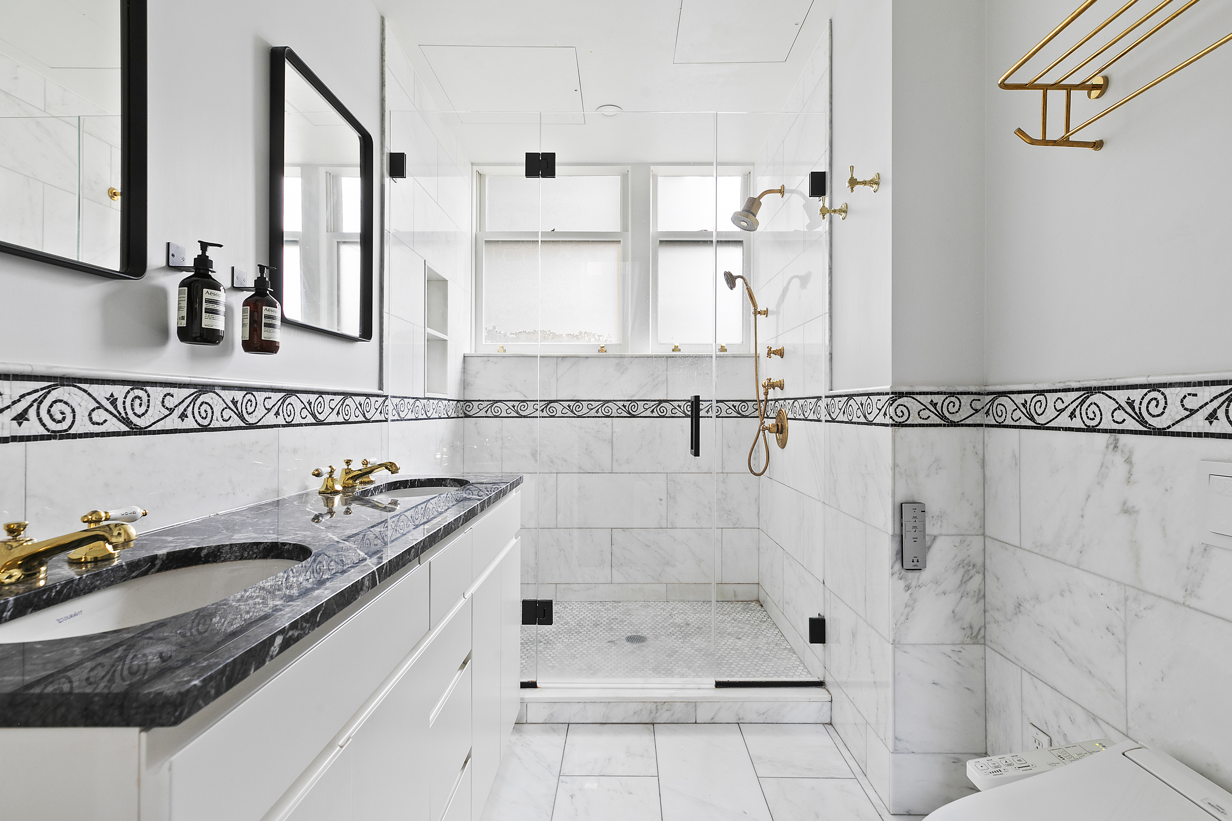31 West 12th Street, Unit 5E Manhattan, NY 10011 - Photo 11 of 14 a bathroom with a granite countertop sink a mirror and shower