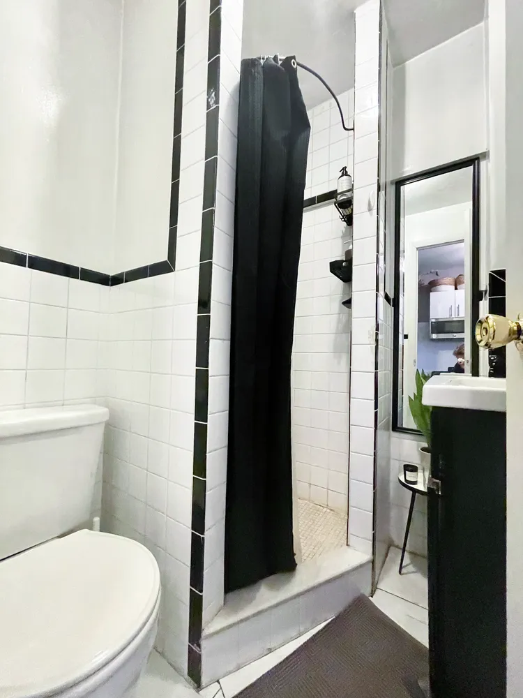 a bathroom with a toilet and a shower