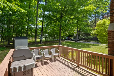 a view of a patio with table and chairs and wooden floor