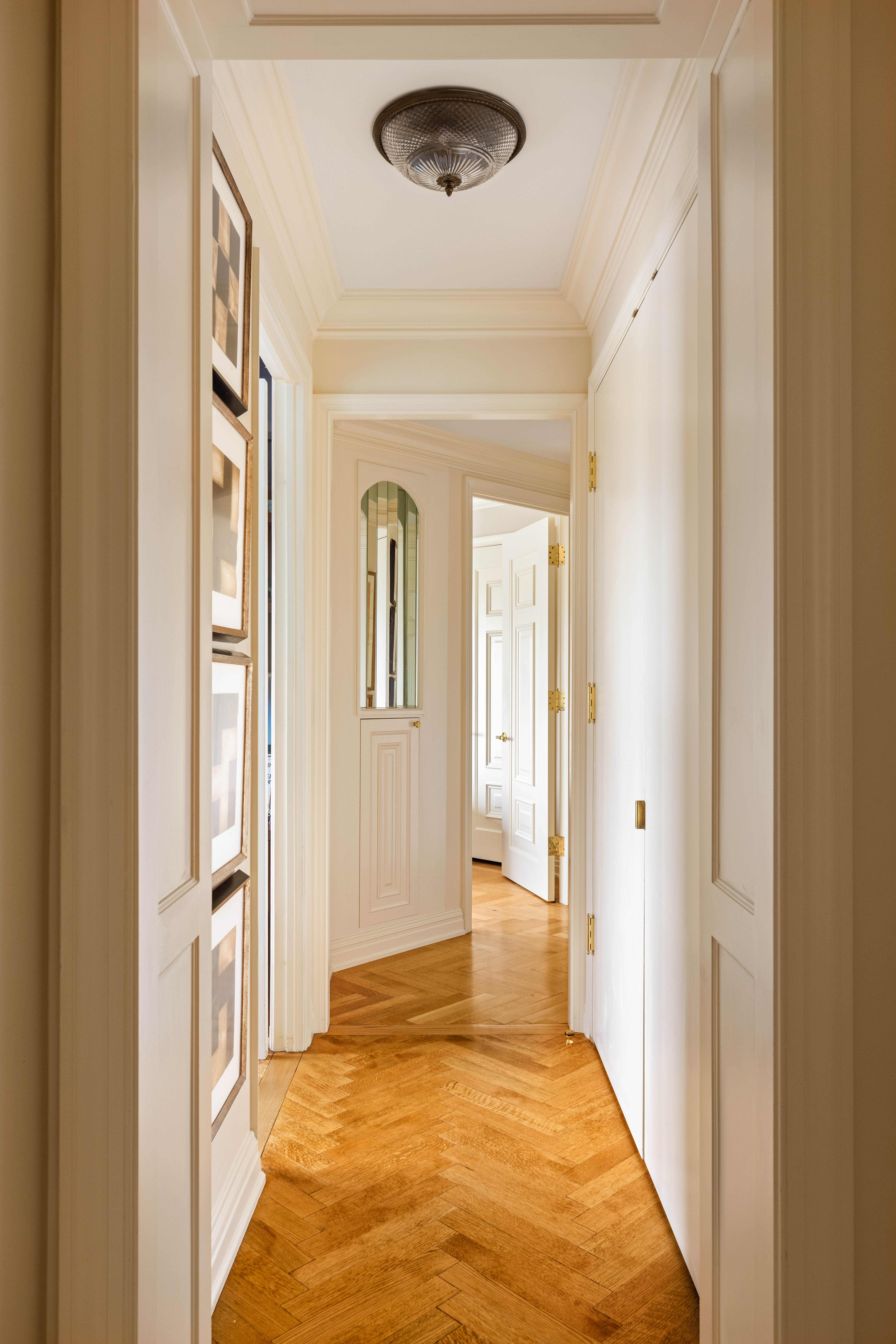 530 East 76th Street, Unit 8CD Manhattan, NY 10021 - Photo 11 of 21 a view of a hallway view with wooden floor and staircase