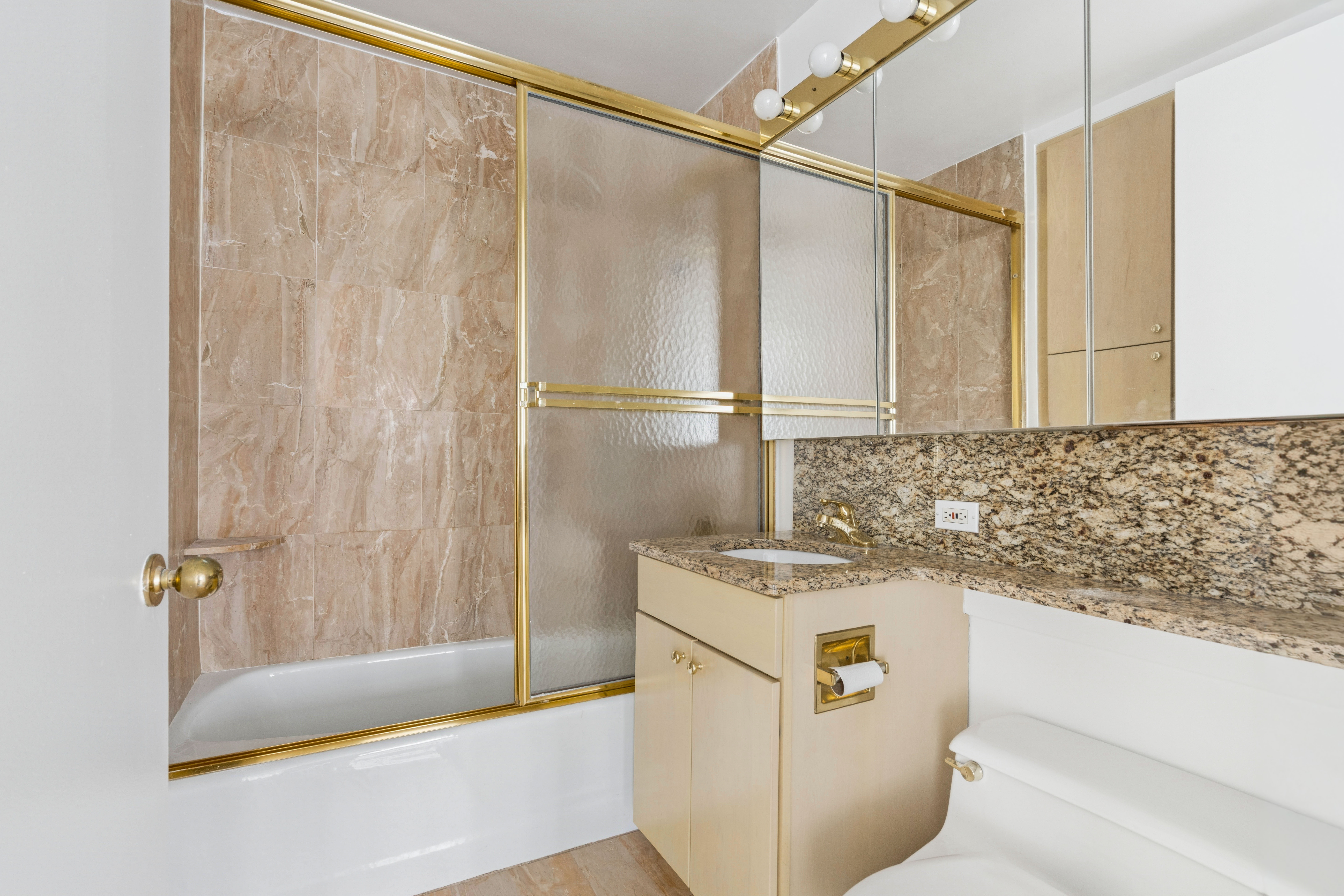 201 West 72nd Street, Unit 8A Manhattan, NY 10023 - Photo 12 of 15 a bathroom with a sink a bath tub and shower