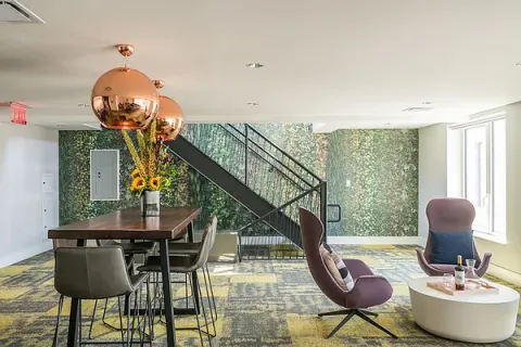 a living room with furniture and floor to ceiling windows
