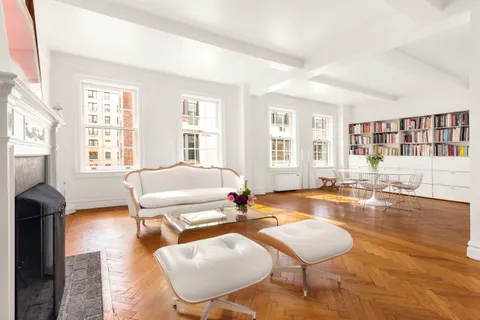 a living room with fireplace furniture and a large window