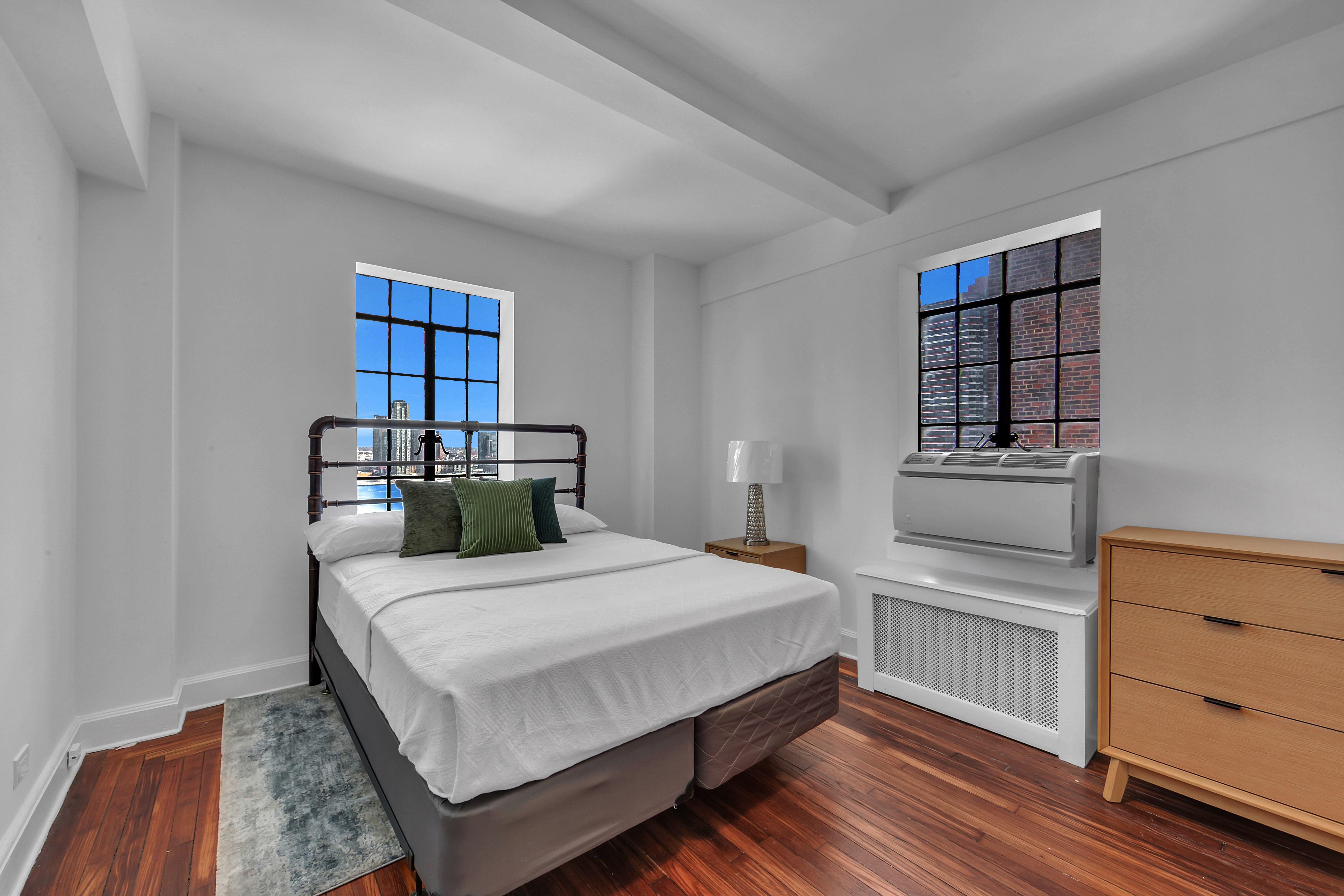 5 Tudor City Place, Unit 1536 Manhattan, NY 10017 - Photo 4 of 21 a bedroom with a bed and a window