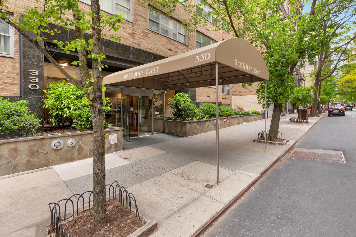 330 East 49th Street, Unit 3E Manhattan, NY 10017 - Photo 5 of 5 a view of a patio with a table and chairs under an umbrella