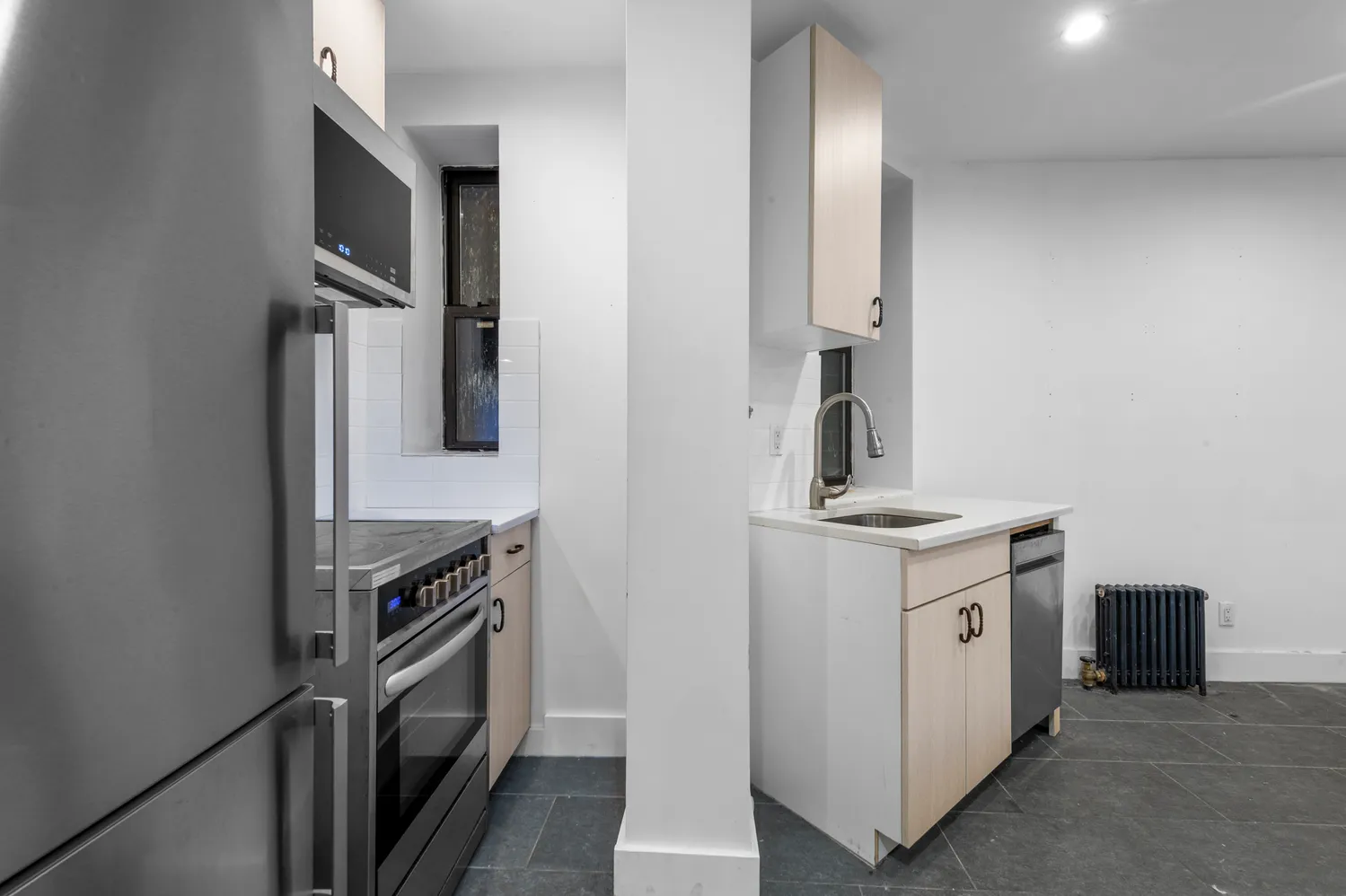 a kitchen with granite countertop a sink and a stove top oven