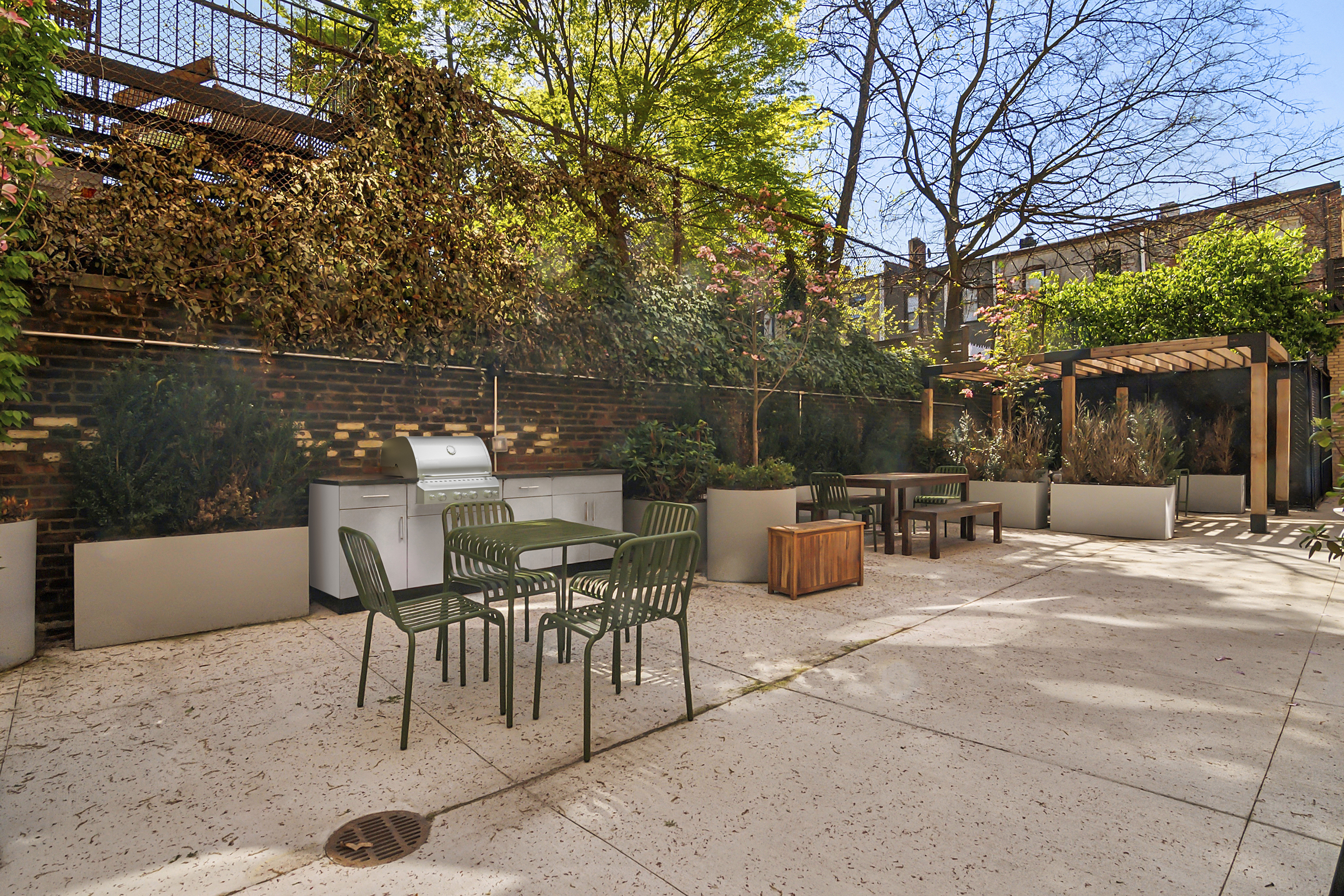 180 Bainbridge Street, Unit 112 Brooklyn, NY 11233 - Photo 9 of 30 a view of a patio with a dining table and chairs with a fire pit