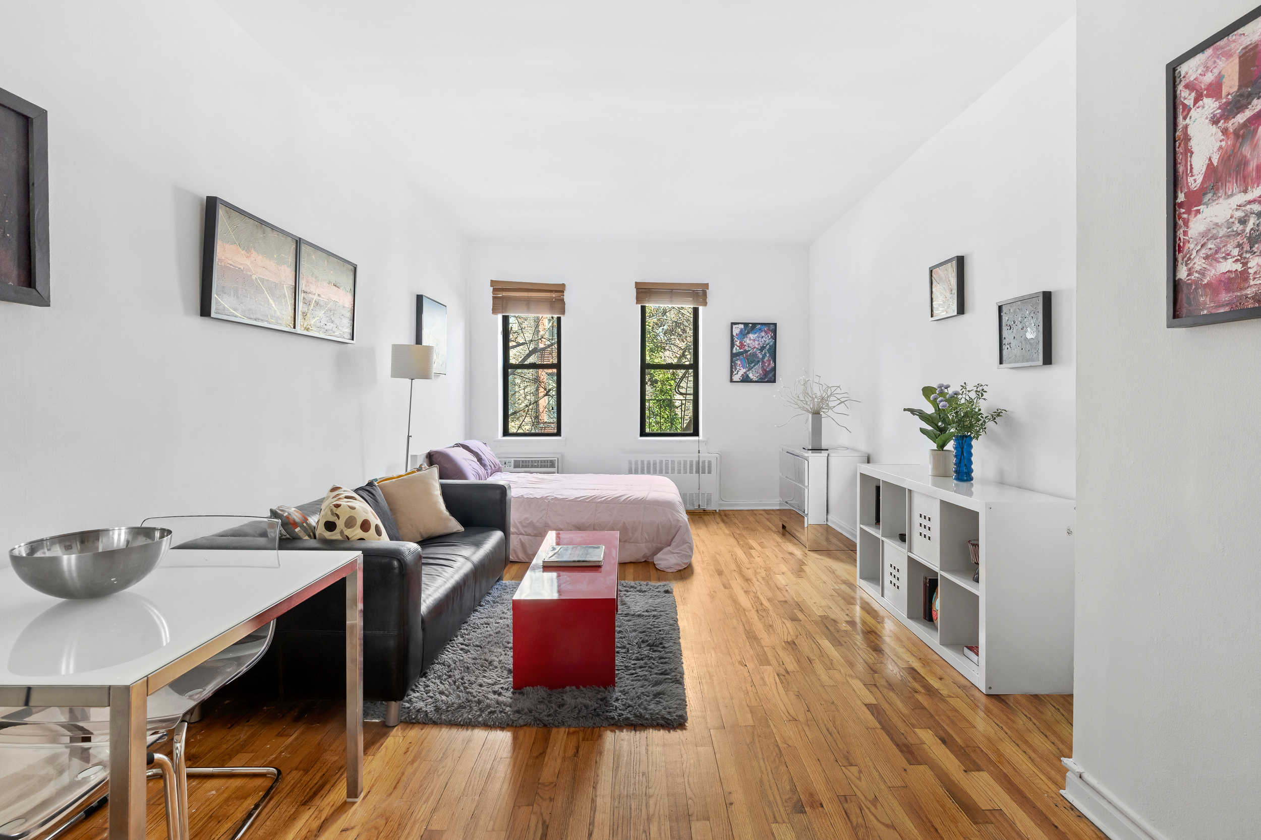 205 East 89th Street, Unit C4 Manhattan, NY 10128 - Photo 2 of 7 a living room with furniture and a wooden floor