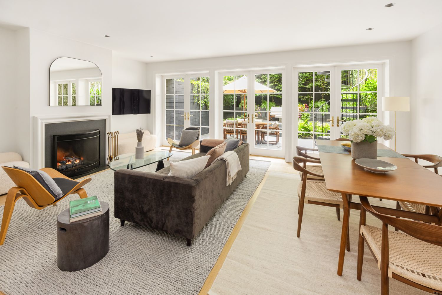 a living room with furniture a fireplace and a flat screen tv