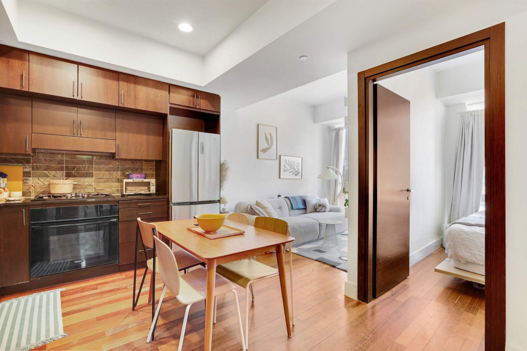 150 Myrtle Avenue, Unit 1105 Brooklyn, NY 11201 - Photo 4 of 24 a view of a dining room with furniture a kitchen and chandelier
