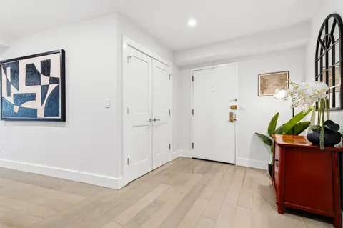 a view of an entryway with wooden floor
