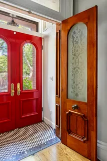 a view of front door with a mirror