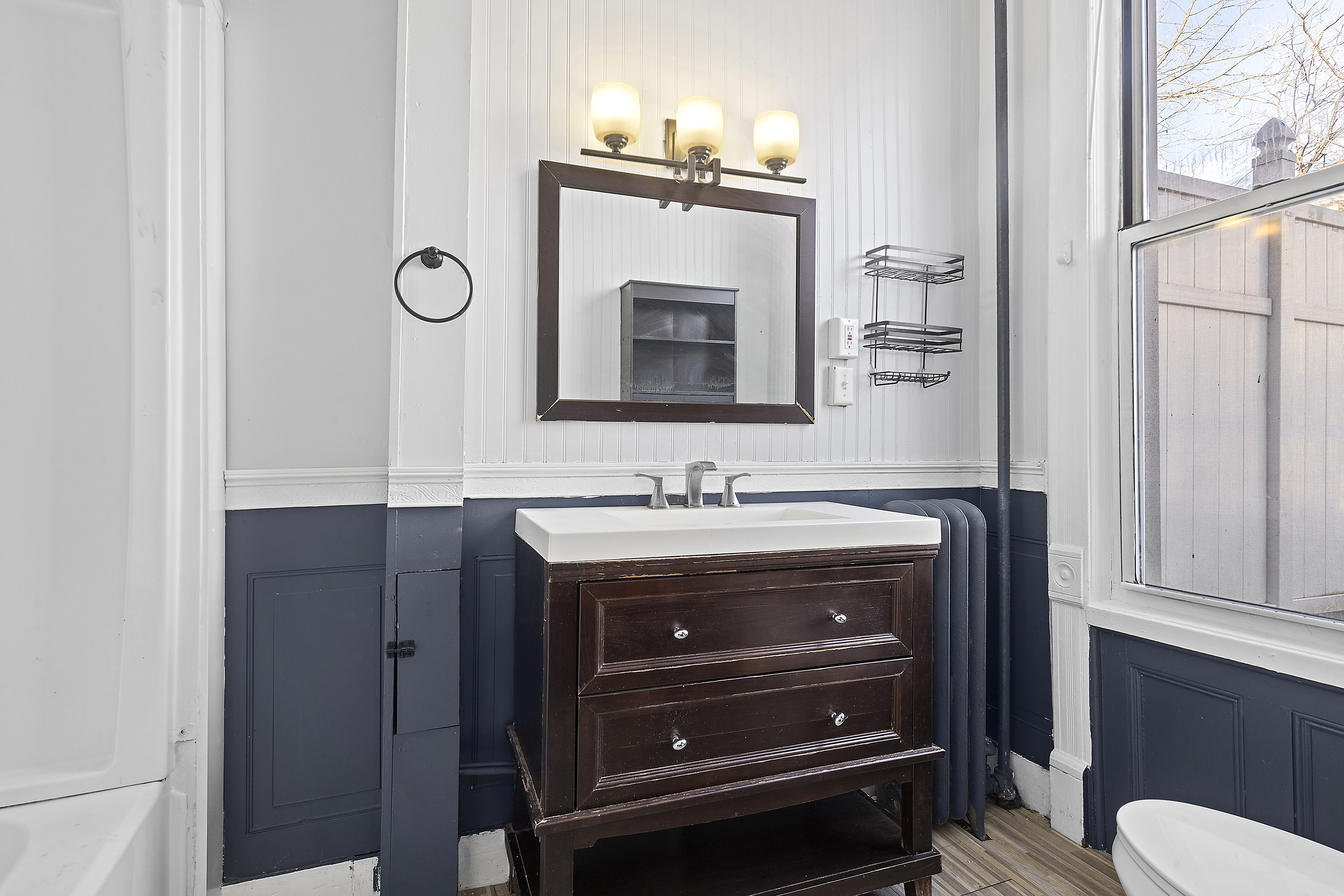 693 MacDonough Street, Unit 2 Brooklyn, NY 11233 - Photo 7 of 11 a bathroom with a mirror and a sink