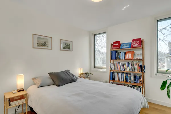 a bedroom with a bed and a book shelf