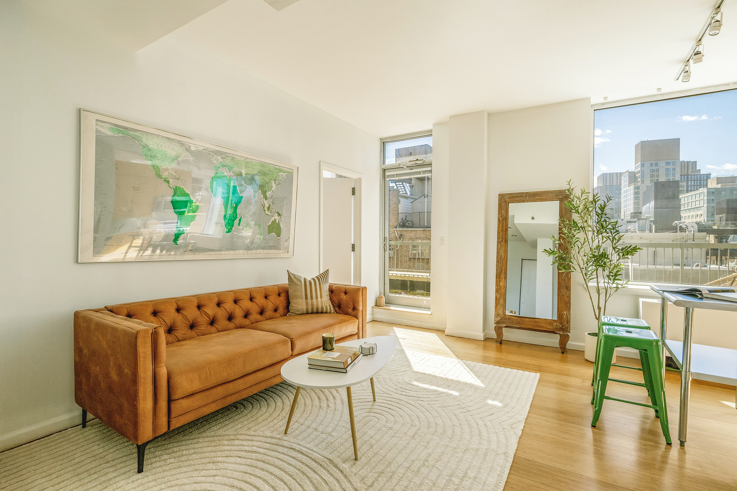 a living room with furniture and a wooden floor