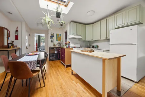 a view of kitchen with cabinets and wooden floor