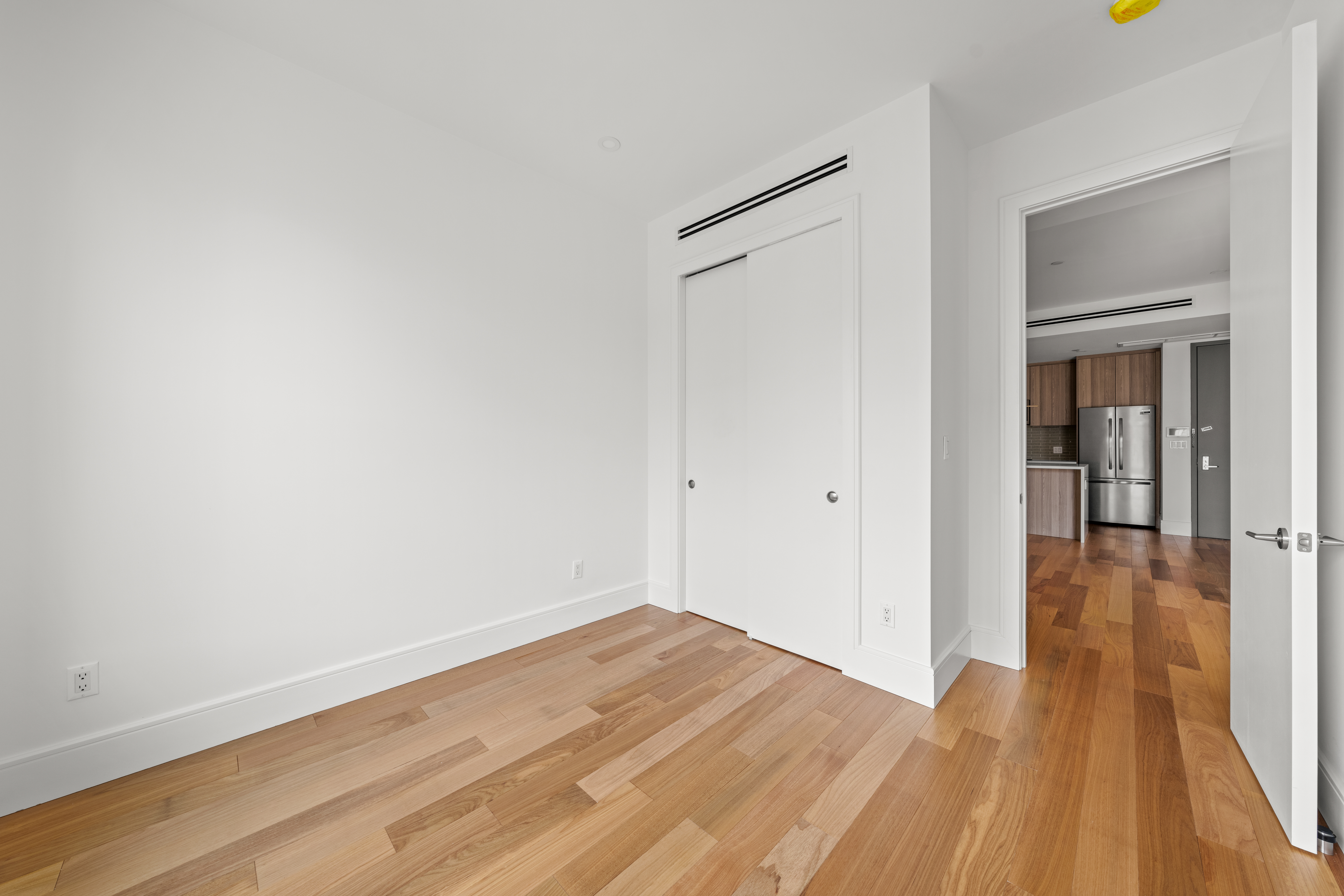82 Cooper Street, Unit 2B Brooklyn, NY 11207 - Photo 9 of 17 a view of a room with wooden floor and a bathroom