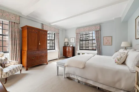 a bedroom with a bed closet and a window