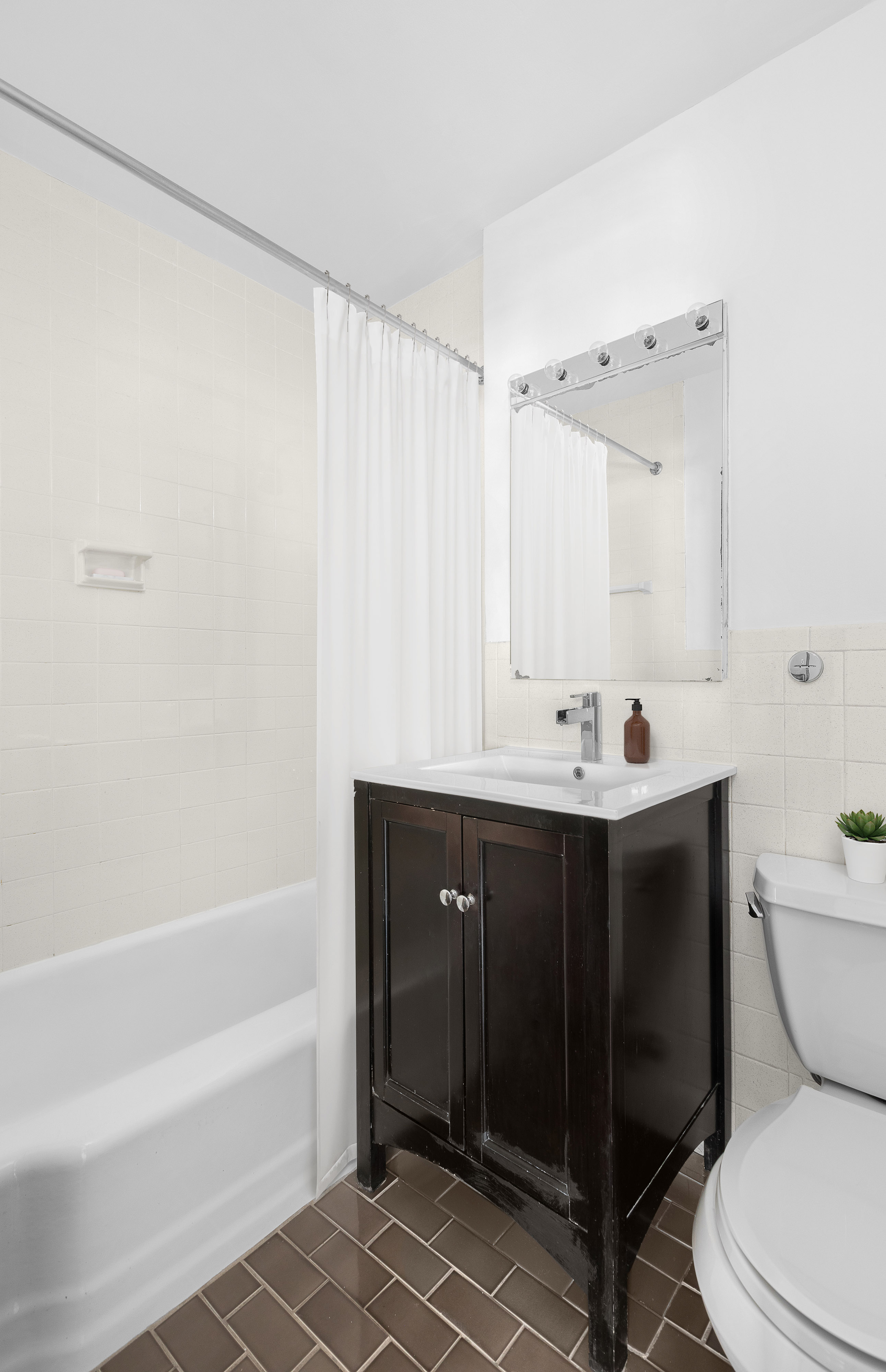 10 West 15th Street, Unit 1721 Manhattan, NY 10011 - Photo 6 of 10 a bathroom with a sink a toilet and shower