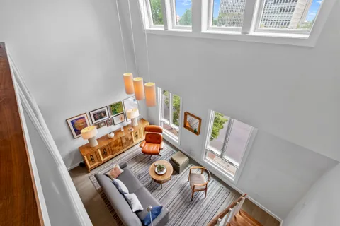 a view of a livingroom with furniture and a flat screen tv