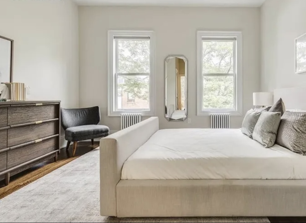 137 West 126th Street, Unit 3 Manhattan, NY 10027 - Photo 2 of 5 a large white bed sitting in a bedroom next to a window