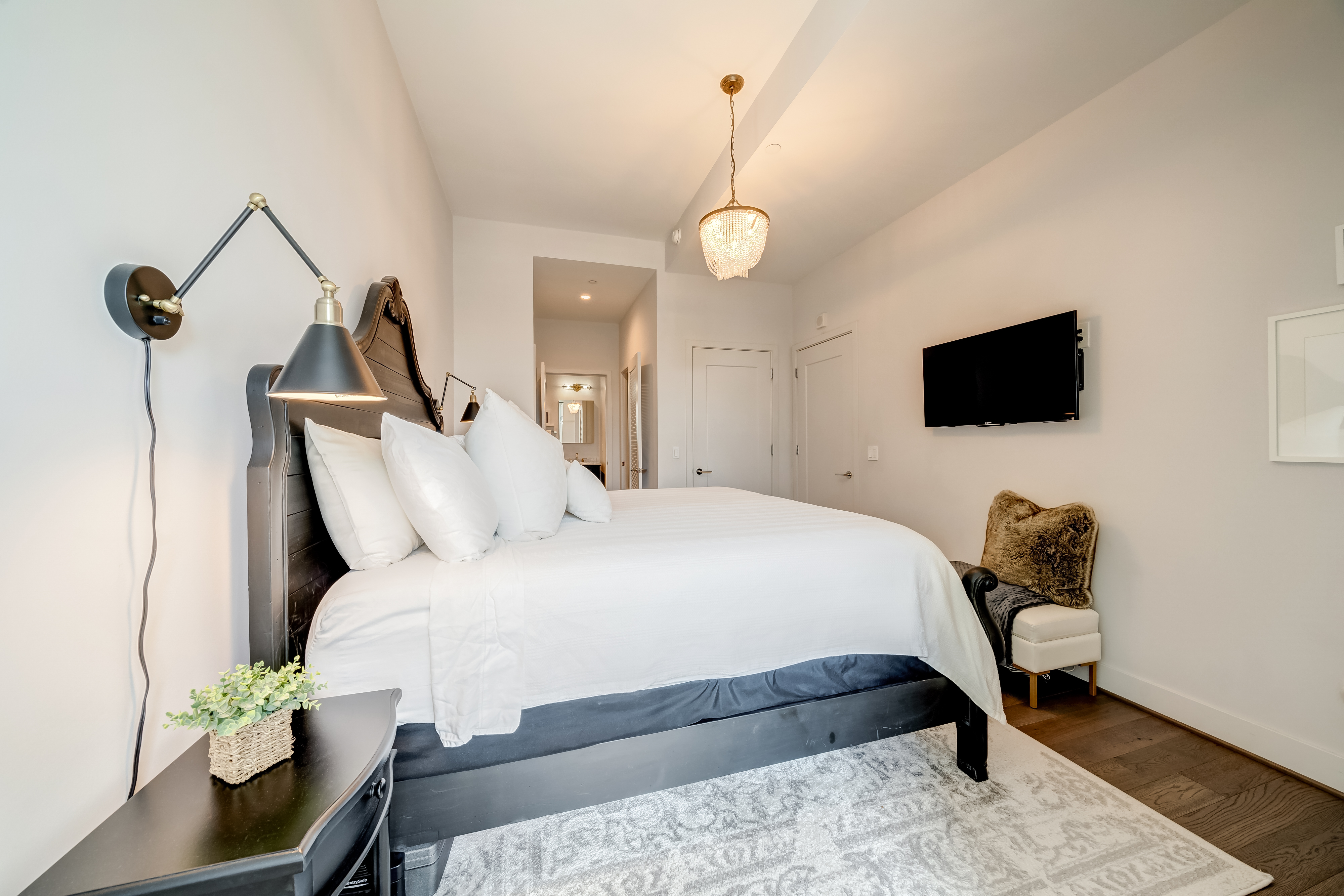 45 Sutton Square Southwest, Unit PH10 Washington, DC 20024 - Photo 24 of 44 a bedroom with bed tv and table