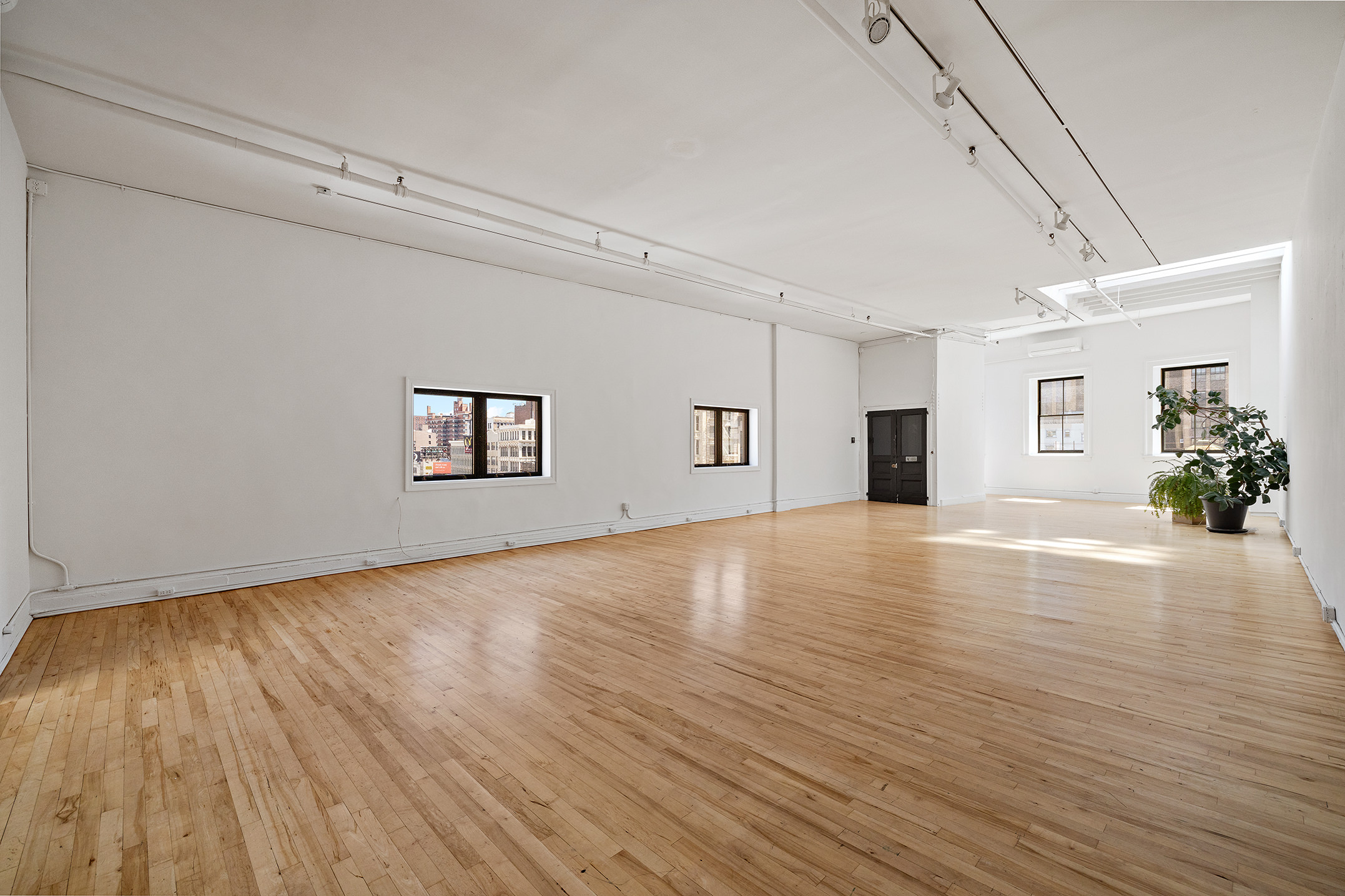 47 Howard Street, Unit 5 Manhattan, NY 10013 - Photo 4 of 9 an empty room with wooden floor and windows