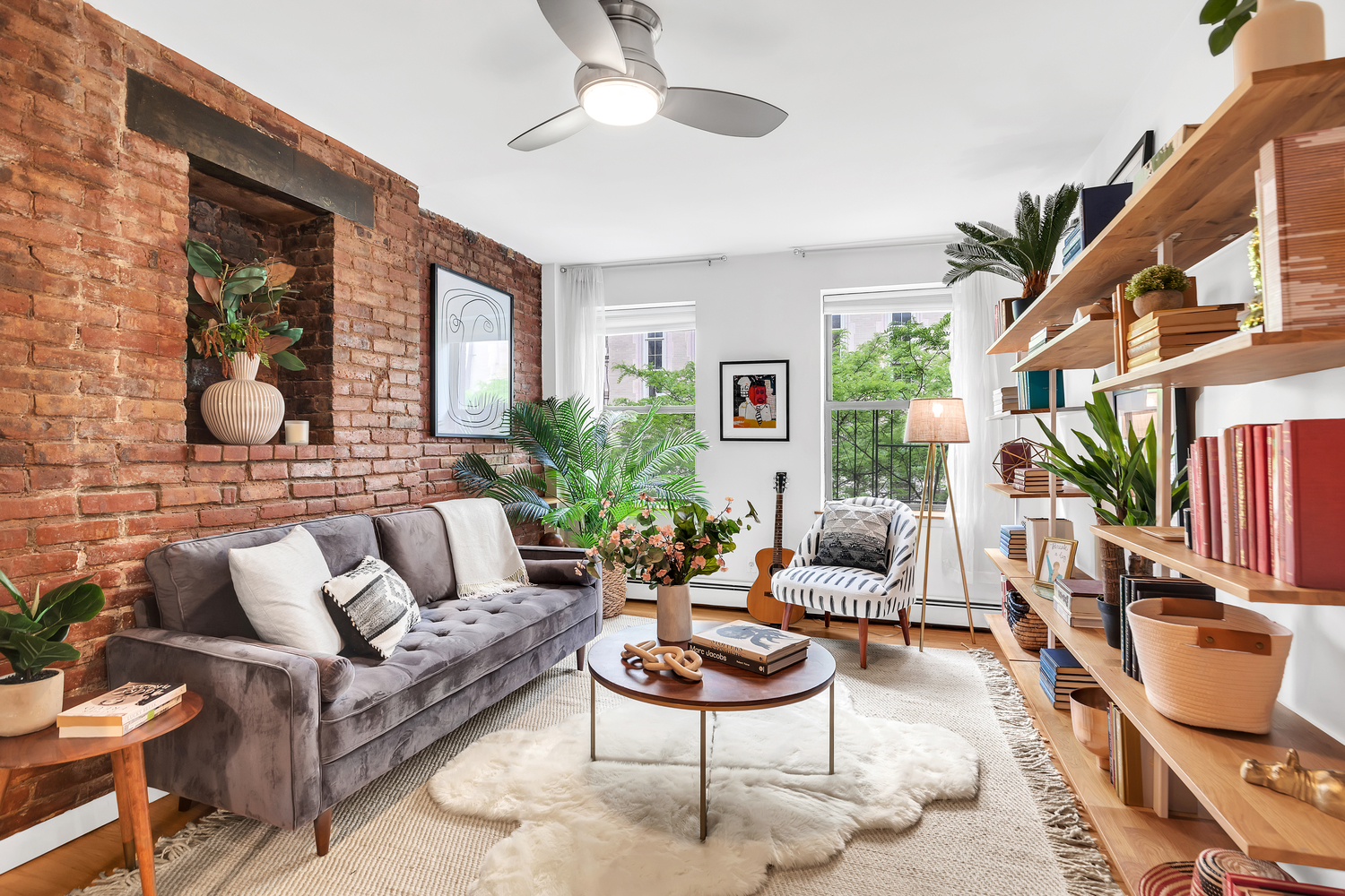 118 Suffolk Street, Unit 3A Manhattan, NY 10002 - Photo 1 of 8 a living room with furniture potted plant and a window