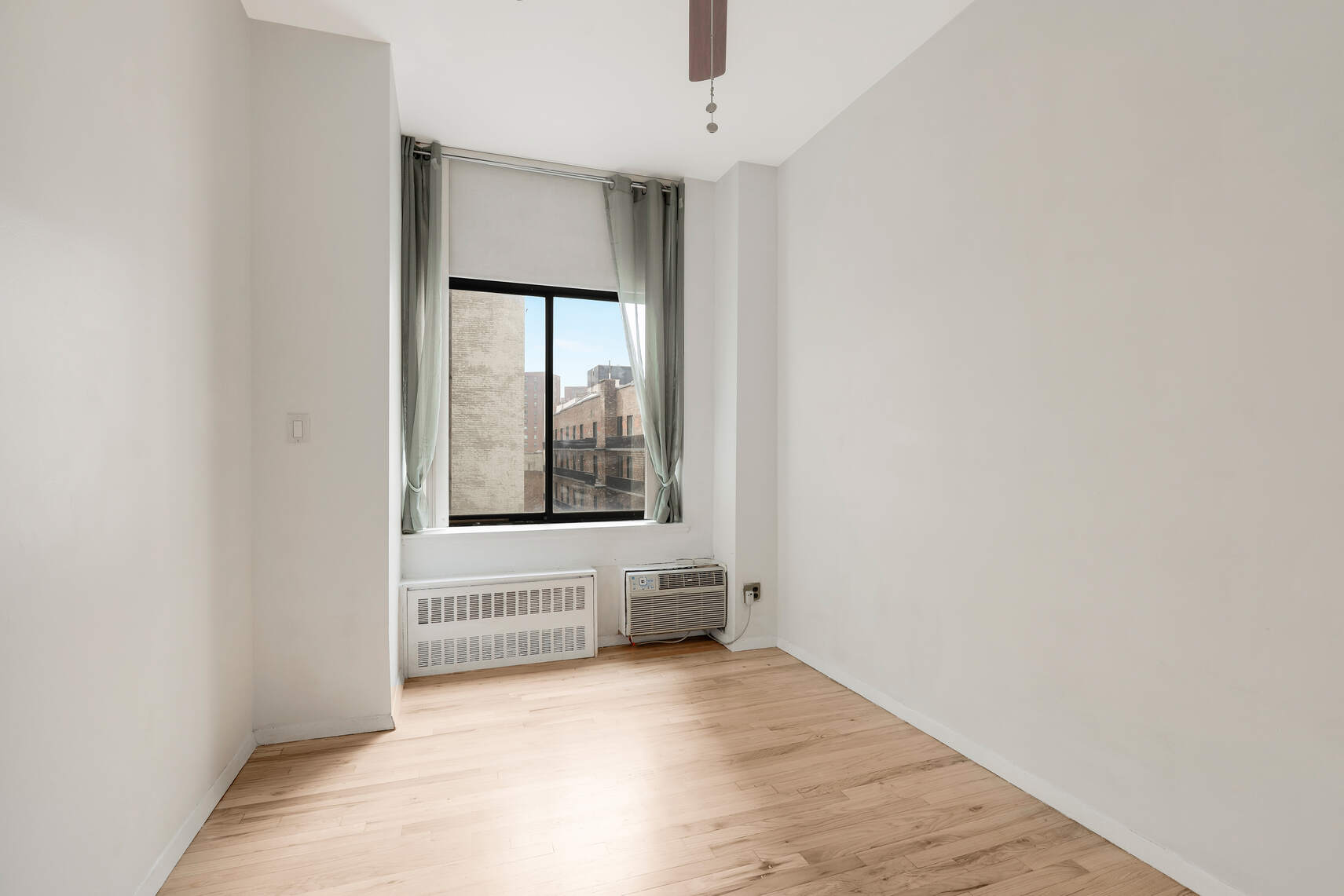 310 East 23rd Street, Unit 5A Manhattan, NY 10010 - Photo 6 of 14 a view of an empty room with a window