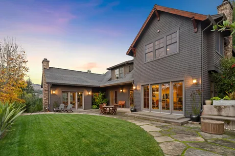 a view of the house with backyard porch and sitting area