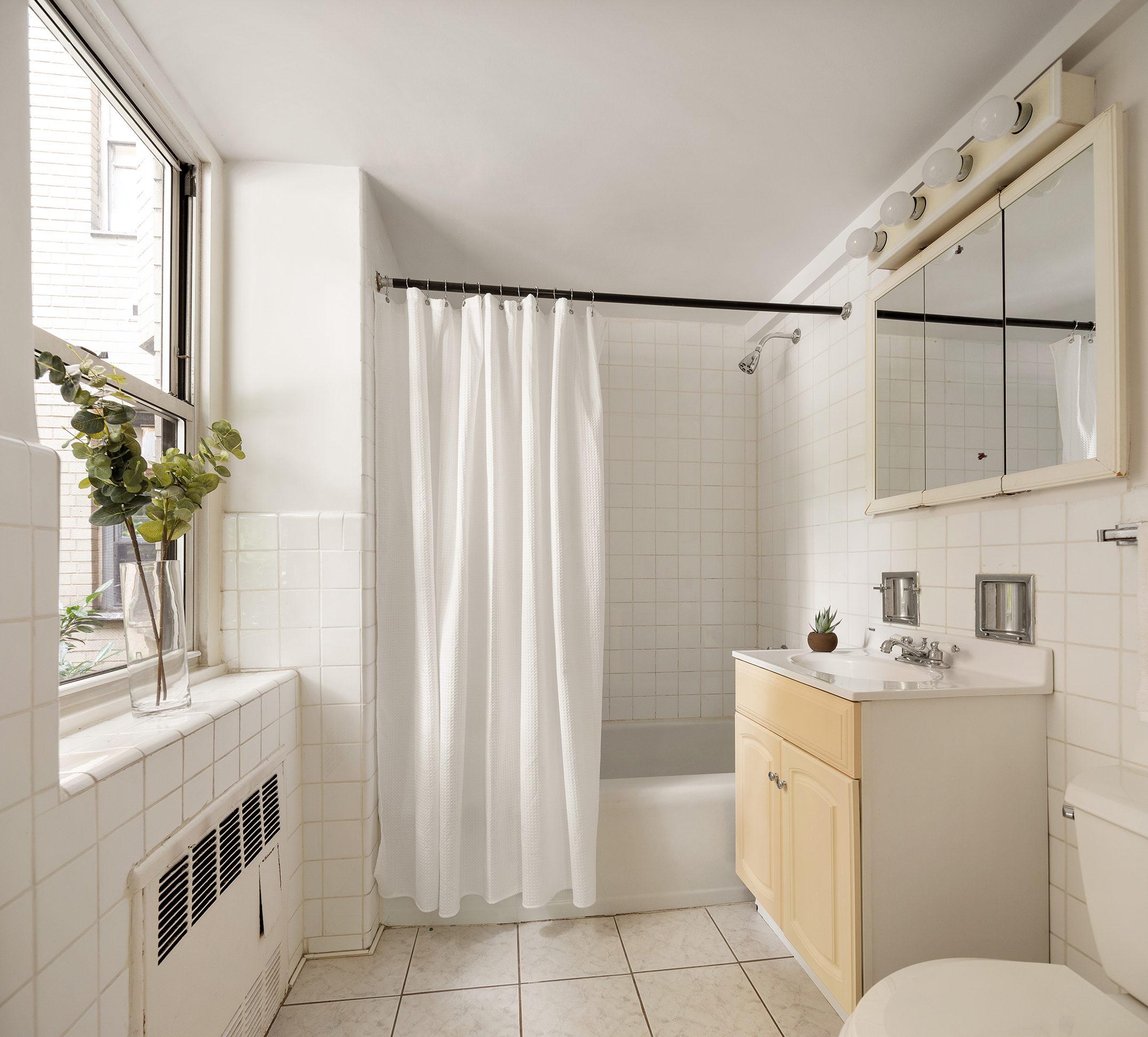180 East End Avenue, Unit 1C Manhattan, NY 10128 - Photo 8 of 19 a bathroom with a sink a toilet and mirror