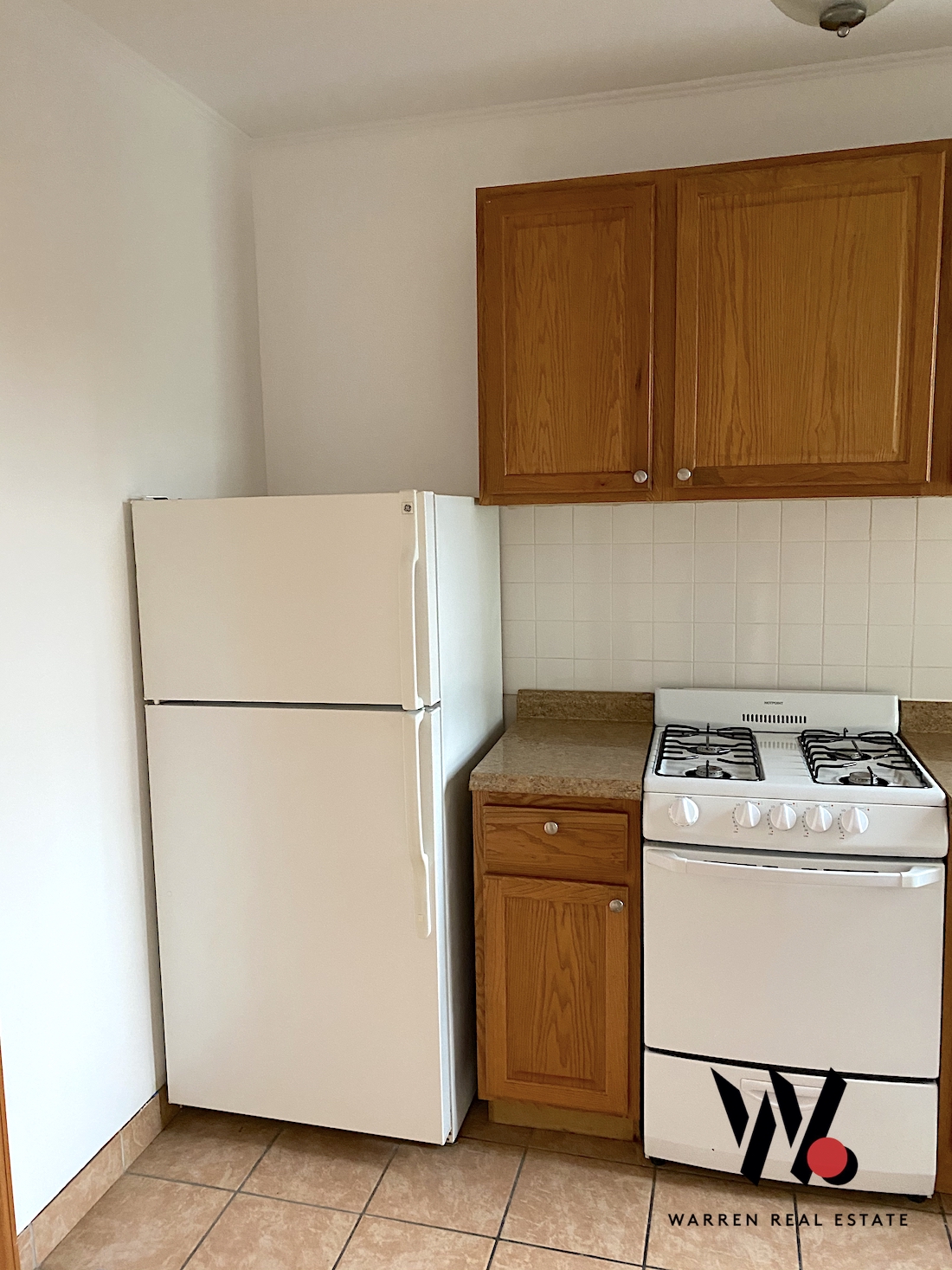 80 East 7th Street, Unit 4D Manhattan, NY 10003 - Photo 5 of 8 a utility room with dryer washer and a fridge